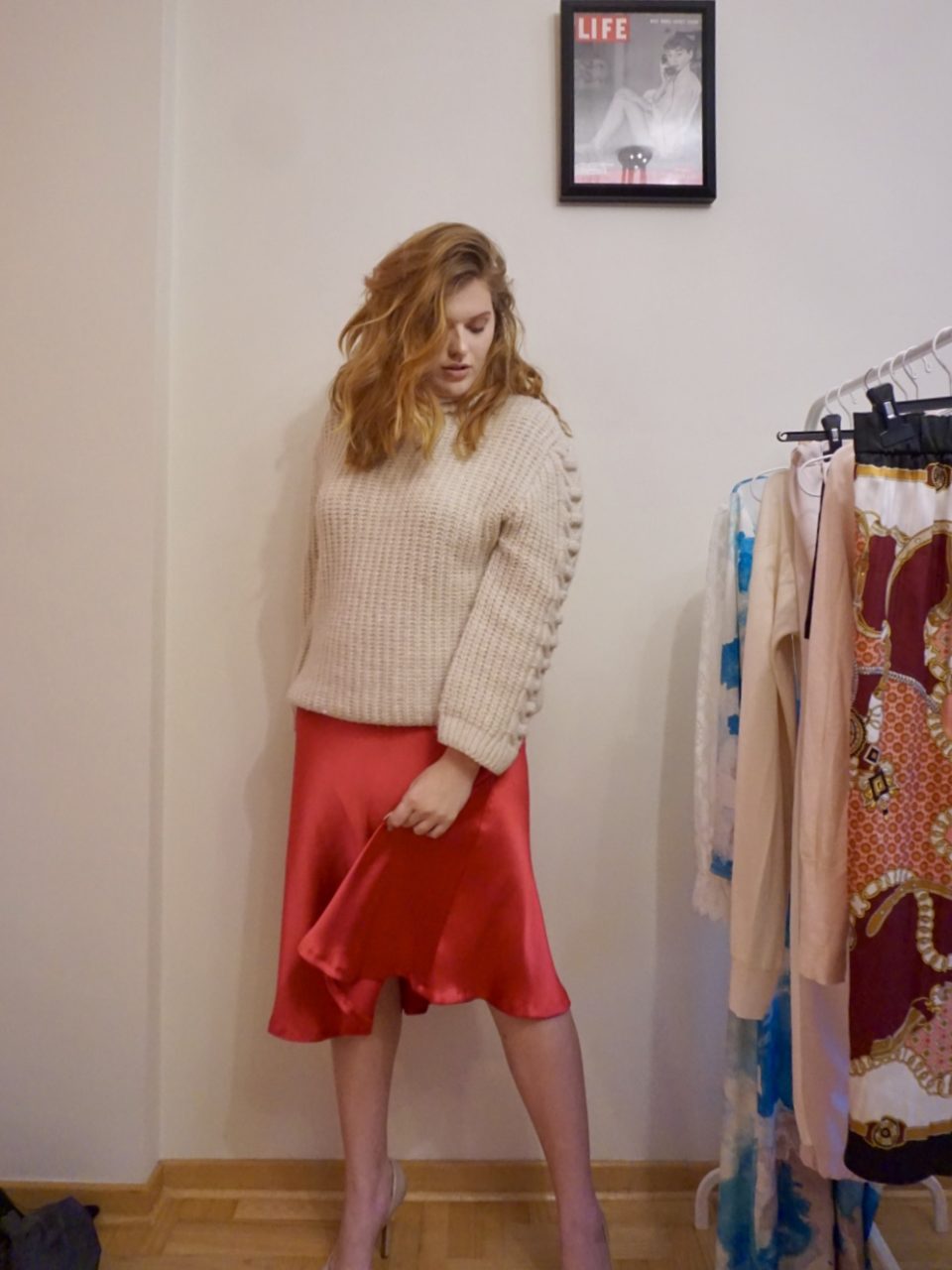 Red satin skirt with chunky knit sweater